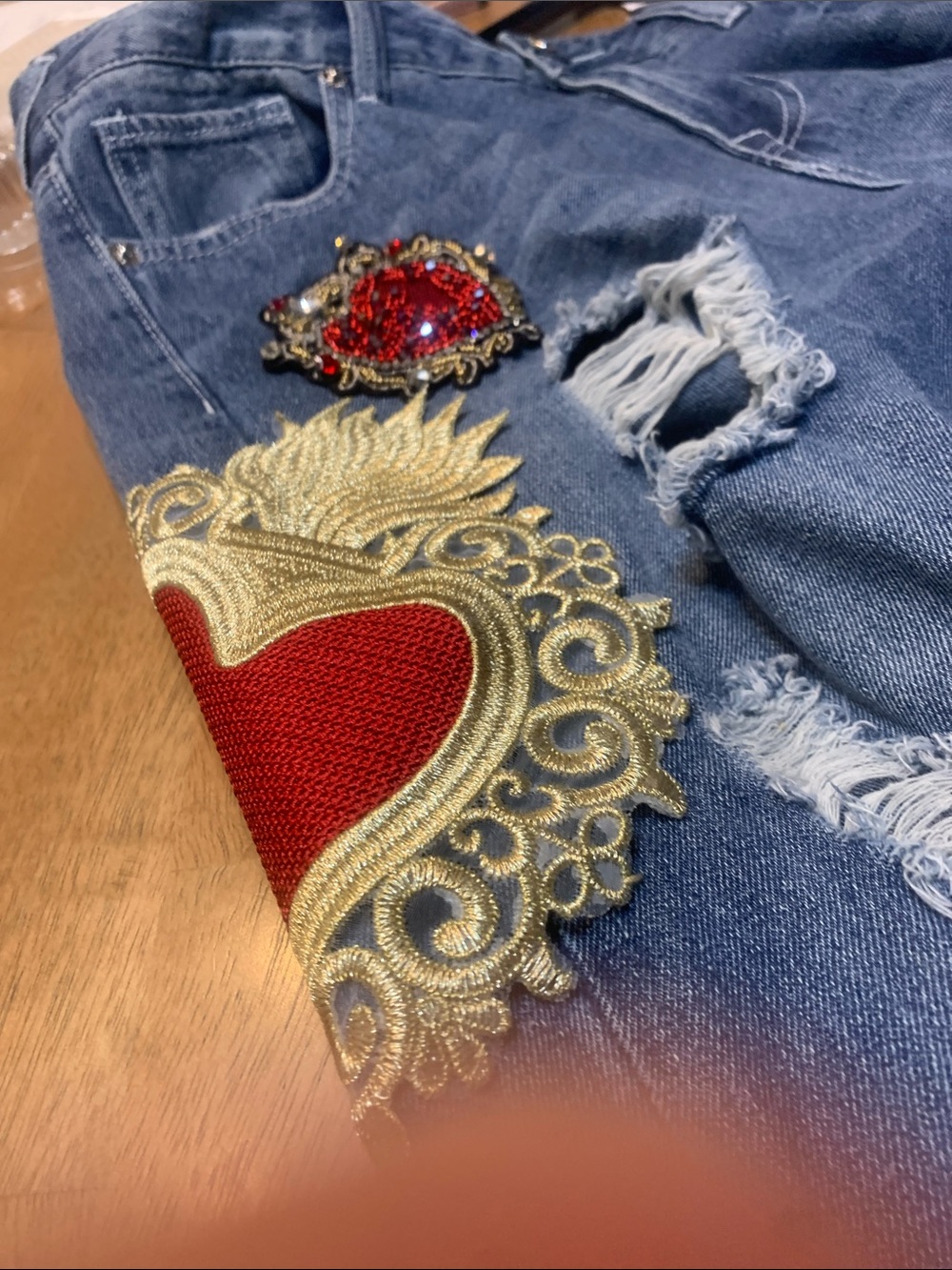 True Religion Blue Distressed Jeans with Red & Gold Heart Appliqués. Tote 4 - Picture 2 of 11